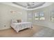 Spacious main bedroom featuring a tray ceiling, natural light, and neutral decor at 7124 Rue De Palisades # 21, Sarasota, FL 34238