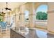 Outdoor kitchen island with sink, set against a backdrop of lush landscaping, arches and outdoor seating at 7124 Rue De Palisades # 21, Sarasota, FL 34238