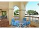 Outdoor seating area with comfortable chairs, a table, and lush tropical scenery, and community pool at 7124 Rue De Palisades # 21, Sarasota, FL 34238