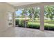 Enclosed patio features neutral tones, screened windows, and views of the landscaped yard at 7124 Rue De Palisades # 21, Sarasota, FL 34238