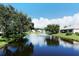 Beautiful water view from this property, featuring lush landscaping and a central fountain at 7124 Rue De Palisades # 21, Sarasota, FL 34238