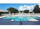 Sparkling swimming pool with lounge chairs and manicured landscaping at 7124 Rue De Palisades # 21, Sarasota, FL 34238