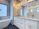 Contemporary bathroom featuring a glass shower, soaking tub, and dual sinks at 7152 Bougainvillea St, Englewood, FL 34224