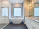 Modern bathroom featuring a glass shower, soaking tub and stylish vanity at 7152 Bougainvillea St, Englewood, FL 34224