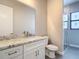Well-lit bathroom featuring white cabinets, granite countertop, gold fixtures and a modern glass door shower at 7152 Bougainvillea St, Englewood, FL 34224