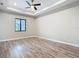 Spacious bedroom with tray ceiling, ceiling fan, and luxury vinyl plank flooring at 7152 Bougainvillea St, Englewood, FL 34224