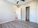 Bedroom featuring wood-look floors, ceiling fan, an open closet and ensuite bathroom at 7152 Bougainvillea St, Englewood, FL 34224