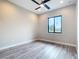Spacious bedroom featuring wood-look floors, a ceiling fan, and a bright window with natural light at 7152 Bougainvillea St, Englewood, FL 34224