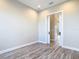 Bedroom with wood floors, neutral walls, and sliding door entryway at 7152 Bougainvillea St, Englewood, FL 34224
