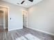 Bedroom featuring wood-look floors, a ceiling fan, and multiple doorways at 7152 Bougainvillea St, Englewood, FL 34224