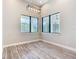 Bright dining room with a contemporary chandelier and large windows offering great natural light at 7152 Bougainvillea St, Englewood, FL 34224