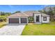 Beautiful home featuring a two-car garage, enhanced curb appeal, and manicured lawn creating a welcoming atmosphere at 7152 Bougainvillea St, Englewood, FL 34224