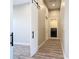 Hallway leading to laundry room with washer and dryer at 7152 Bougainvillea St, Englewood, FL 34224