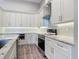 Bright kitchen featuring white cabinets, granite countertops, tile backsplash, and stainless steel appliances at 7152 Bougainvillea St, Englewood, FL 34224