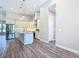 Spacious kitchen featuring granite countertops, a large island with a sink, and stainless steel appliances at 7152 Bougainvillea St, Englewood, FL 34224