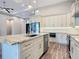 Spacious kitchen featuring granite countertops, a large island with a sink, and stainless steel appliances at 7152 Bougainvillea St, Englewood, FL 34224