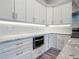 New kitchen with white cabinets, granite countertops and backsplash, and stainless steel appliances at 7152 Bougainvillea St, Englewood, FL 34224