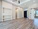 Bright and open living room featuring wood floors, modern lighting, and neutral wall paint at 7152 Bougainvillea St, Englewood, FL 34224