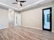 Spacious main bedroom with tray ceiling, ceiling fan, and luxury vinyl plank flooring at 7152 Bougainvillea St, Englewood, FL 34224
