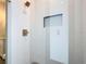 Shower featuring herringbone tile and gold fixtures, creating a clean and stylish space at 7152 Bougainvillea St, Englewood, FL 34224