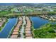 Aerial view of a neighborhood with waterfront homes, golf course, and lake at 8911 Heritage Sound Dr, Bradenton, FL 34212