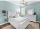 Bright bedroom with white furniture, wood floors, area rug, and coastal decor at 8911 Heritage Sound Dr, Bradenton, FL 34212