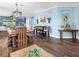 Spacious dining area featuring wood floors, elegant chandelier, and seamless open layout for entertaining guests at 8911 Heritage Sound Dr, Bradenton, FL 34212