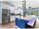 Bright kitchen with stainless appliances, a large island, and sleek white cabinets at 8911 Heritage Sound Dr, Bradenton, FL 34212