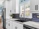 Modern kitchen featuring stainless steel appliances, sleek cabinetry, dark backsplash, and granite countertops at 8911 Heritage Sound Dr, Bradenton, FL 34212