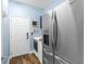 Functional laundry area featuring stainless steel appliances and a chalkboard for notes at 8911 Heritage Sound Dr, Bradenton, FL 34212