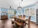Open-concept living space with hardwood floors, large dining table, and stylish decor, perfect for gatherings at 8911 Heritage Sound Dr, Bradenton, FL 34212