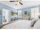 Bright main bedroom featuring a TV, stylish decor, and en-suite bathroom, perfect for relaxation at 8911 Heritage Sound Dr, Bradenton, FL 34212