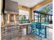 Outdoor kitchen with stainless steel grill and bar seating, perfect for entertaining at 8911 Heritage Sound Dr, Bradenton, FL 34212