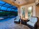 Cozy patio with fire pit and comfortable seating overlooking the pool at 8911 Heritage Sound Dr, Bradenton, FL 34212