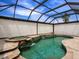 Screened pool with spa and rock waterfall feature and privacy shades at 8911 Heritage Sound Dr, Bradenton, FL 34212