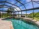 Beautiful screened-in pool area with waterfall features and views of the lake at 8911 Heritage Sound Dr, Bradenton, FL 34212