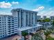 An aerial view displays a modern condo building with a rooftop pool and beautiful balconies at 101 S Gulfstream Ave # 16C, Sarasota, FL 34236