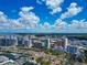 Stunning aerial view of the Sarasota skyline featuring high-rise buildings, beautiful bay, and a vibrant cityscape under blue sky at 101 S Gulfstream Ave # 16C, Sarasota, FL 34236