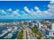 Expansive aerial view of coastal Sarasota, showcasing modern high-rise condos, a marina filled with boats, and scenic waterfront views at 101 S Gulfstream Ave # 16C, Sarasota, FL 34236