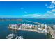 Beautiful aerial view of waterfront condo community with bridge to mainland and boat docks at 101 S Gulfstream Ave # 16C, Sarasota, FL 34236