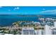 Scenic aerial view showcases Sarasota's bay with yachts, connected islands, bridge, and luxury waterfront condos under a bright sky at 101 S Gulfstream Ave # 16C, Sarasota, FL 34236