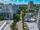 Aerial shot of buildings showcases a mix of architectural styles nestled among lush greenery at 101 S Gulfstream Ave # 16C, Sarasota, FL 34236