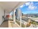 Enjoy city views from the balcony with modern glass railings, a table, and comfortable seating at 101 S Gulfstream Ave # 16C, Sarasota, FL 34236