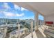 Balcony view with glass railings and seating offers a stunning vista of city buildings and skies at 101 S Gulfstream Ave # 16C, Sarasota, FL 34236
