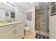 Bright bathroom featuring tiled shower with glass door, sink, and updated fixtures at 101 S Gulfstream Ave # 16C, Sarasota, FL 34236