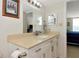 Bathroom with white vanity, tile floor and shower, framed mirror, and neutral color palette at 101 S Gulfstream Ave # 16C, Sarasota, FL 34236