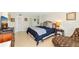 The bedroom features tile floors, a comfortable bed with a blue quilt, and a leather chair at 101 S Gulfstream Ave # 16C, Sarasota, FL 34236
