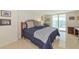 Bright bedroom featuring modern furnishings, neutral walls, and a sliding door leading to the balcony at 101 S Gulfstream Ave # 16C, Sarasota, FL 34236