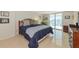 Comfortable bedroom with a large window and sliding glass doors leading to the balcony at 101 S Gulfstream Ave # 16C, Sarasota, FL 34236