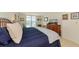 Bright bedroom features a comfortable bed, dresser with TV, and balcony access with a city view at 101 S Gulfstream Ave # 16C, Sarasota, FL 34236